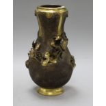 A Japanese Meiji period bronze vase of shaped ovoid form, applied with crabs and weed and having