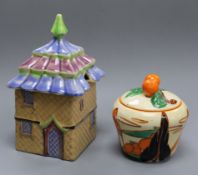 A Clarice Cliff Fantasque Bizarre 'Orange Trees and House' preserve pot and cover, shape 230 and a