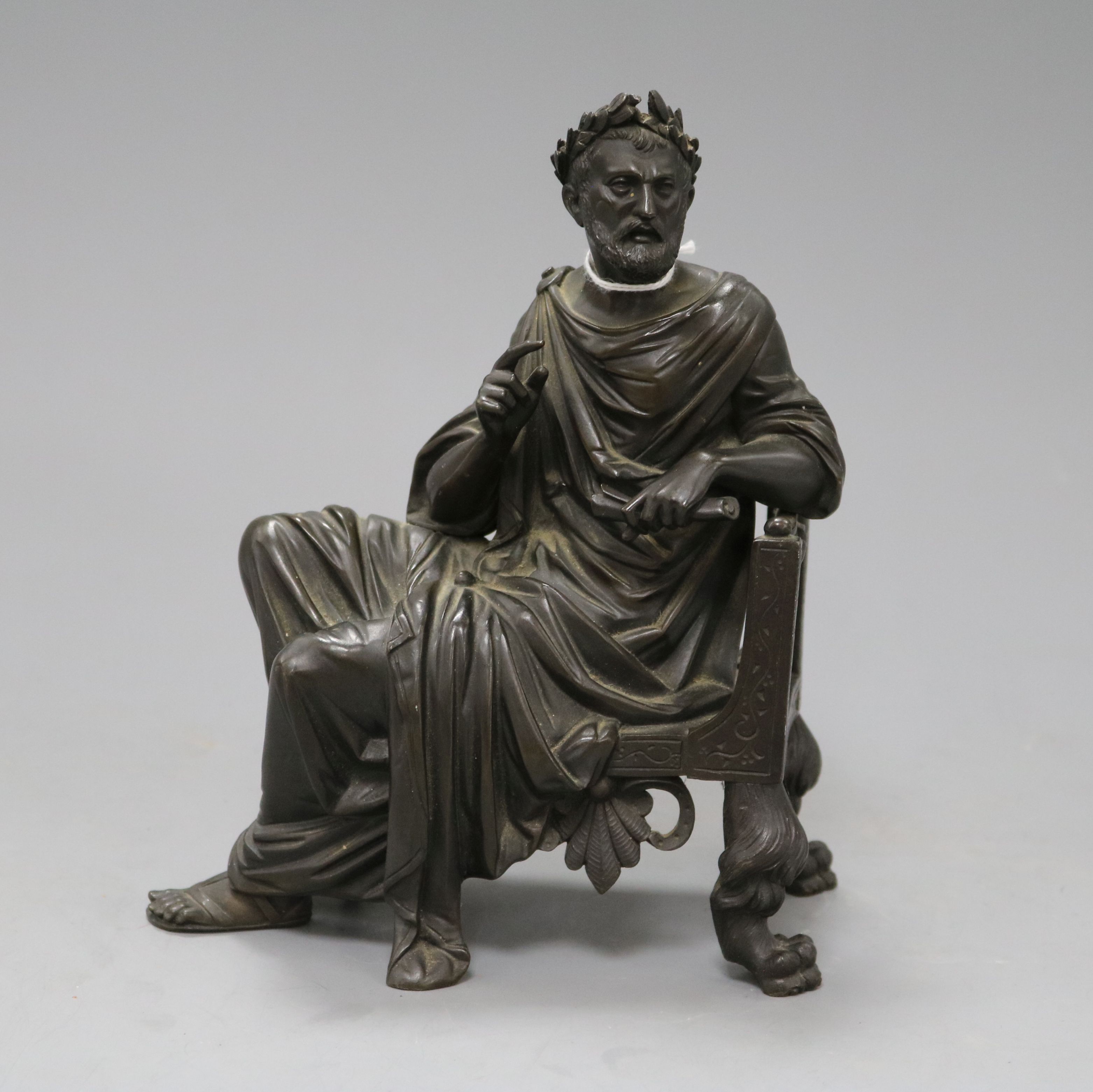 A French 19th century bronze figure of a seated classical scholar, wearing robes and laurel wreath