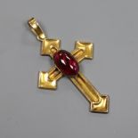 A yellow metal and cabochon garnet set cross pendant, 43mm.