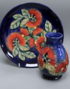A Moorcroft Sally Tuffin Pohutukawa pattern vase, H 13cm and a trial plate in the same design, 1992