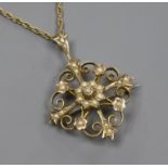 An Edwardian 9ct gold and seed pearl set pendant brooch, on a later 9ct gold ropetwist chain,