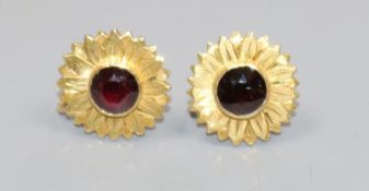 A pair of 18ct gold and garnet flower head ear clips, stamped, G. Dalgleish, 18mm.
