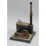 An early 20th century tinplate stationery engine with boiler and chimney, probably Bing