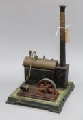 An early 20th century tinplate stationery engine with boiler and chimney, probably Bing