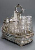 A Georgian composite silver eight-bottle cruet stand of shaped rectangular form, with wooden base,