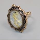 An early 20th century 9ct gold, quartz with iron pyrites and black enamel oval ring, size L.