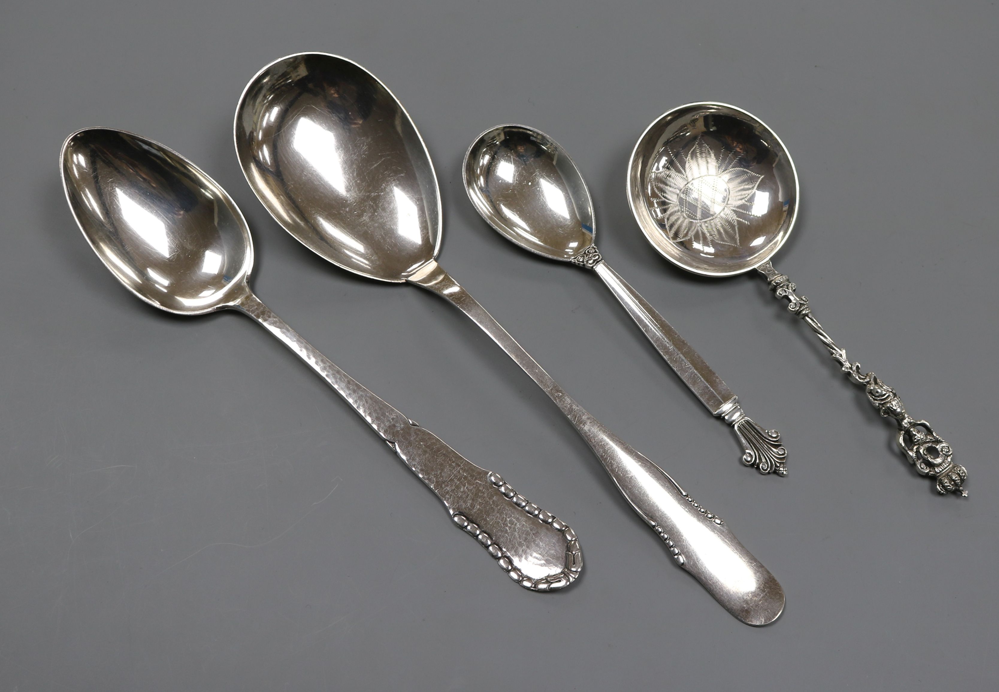 A Georg Jensen sterling silver spoon, two 1920's Danish white metal spoons and a Swedish white metal