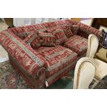 A very large two seater settee, upholstered with an Egyptian taste red, black and cream fabric W.