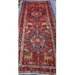 A Caucasian red ground hall carpet 257 x 109cm