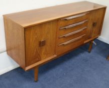 A small McIntosh teak sideboard, fitted four drawers flanked by cupboards W.140cm