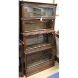 An Inglesants walnut four-section glazed bookcase flanked by reeded columns W.87cm