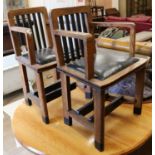A pair of oak elbow chairs
