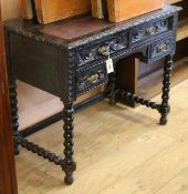 A late Victorian carved oak writing table W.90cm