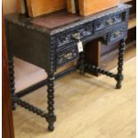 A late Victorian carved oak writing table W.90cm