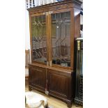 A large mahogany bookcase with double astragal glazed doors and cupboard beneath W.125cm