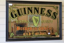 A Guinness advertising mirror W.94cm