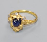 An early 20th century French? yellow metal, cabochon sapphire and diamond set dress ring, size L.