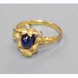 An early 20th century French? yellow metal, cabochon sapphire and diamond set dress ring, size L.