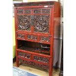 A Chinese red lacquered carved hardwood cupboard W.104cm