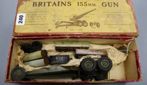 A boxed Britains 155mm model gun and a German tinplate small gauge loco tender and four carriages
