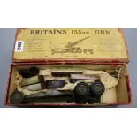A boxed Britains 155mm model gun and a German tinplate small gauge loco tender and four carriages
