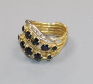 A yellow metal multi shank, sapphire and diamond dress ring, size K.