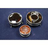 Three circular silver and tortoiseshell trinket boxes, two with pique decoration, one with wreath