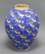 A large Studio pottery vase of ovoid form, decorated all over with fish swimming on a blue ground