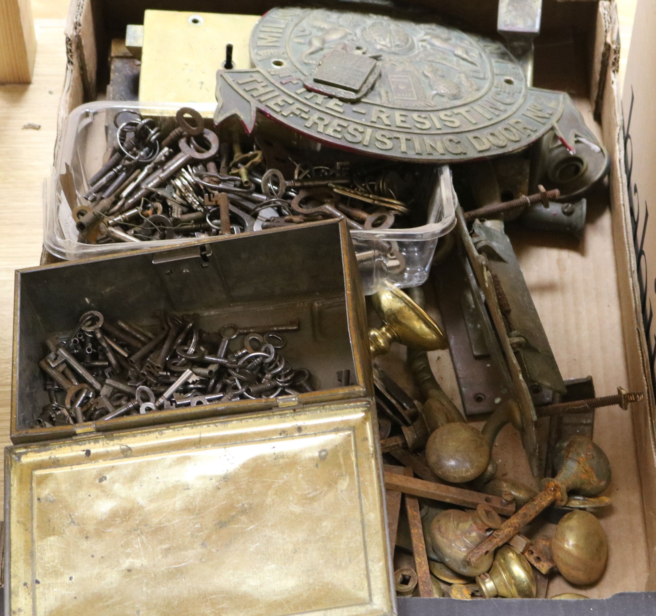 A quantity of mixed metal door furniture, keys etc