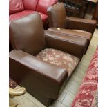 A pair of leather club chairs