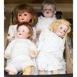 A group of four bisque-headed dolls with jointed composition bodies, including a Schoenau &