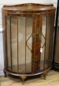 A lacquered bow-fronted display cabinet W.90cm