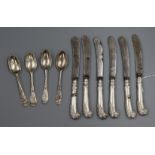 A set of six George V silver pistol handled fruit knives, a set of four unmarked lace back