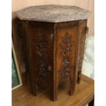 An Indian carved hardwood occasional table W.65cm