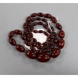 A single strand graduated simulated cherry amber necklace, gross weight 63 grams, 82cm.