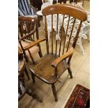 A Victorian elm and beech comb-back elbow chair