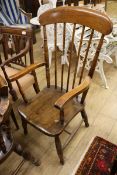 A Victorian elm and beech comb-back elbow chair