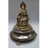 A Buddha and an associated wooden base on claw feet height excl. stand 28.5cm