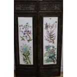 A pair of Chinese porcelain panels, in carved wood frames panels 75 x 21cm