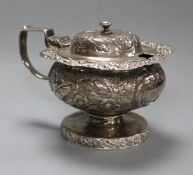 A George IV embossed silver pedestal mustard pot, Abstinando King, London, 1822.