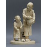 A Japanese ivory group of two figures with basket of oranges height 16cm