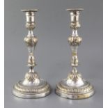 A pair of French Louis XV silver plated candlesticks, with waisted knopped stems, on circular bases,