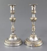 A pair of French Louis XV silver plated candlesticks, with waisted knopped stems, on circular bases,