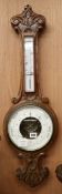 An Edwardian carved oak barometer and thermometer W.25cm