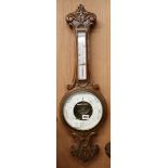 An Edwardian carved oak barometer and thermometer W.25cm
