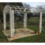 A large white painted wrought iron gazebo This lot may be viewed on site at a property at Pett,