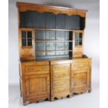 A George III oak breakfront dresser, the associated three shelf rack with two glazed doors, over