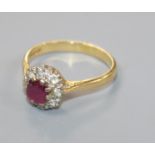 A modern 18ct gold, ruby and diamond cluster ring, size P/Q.