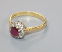 A modern 18ct gold, ruby and diamond cluster ring, size P/Q.
